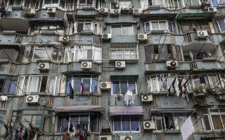 A building in China marked by several window-unit air conditioners. AC units like these can cause moisture buildup and offer the bacterium that causes legionnaire's disease a habitat in which to multiply.